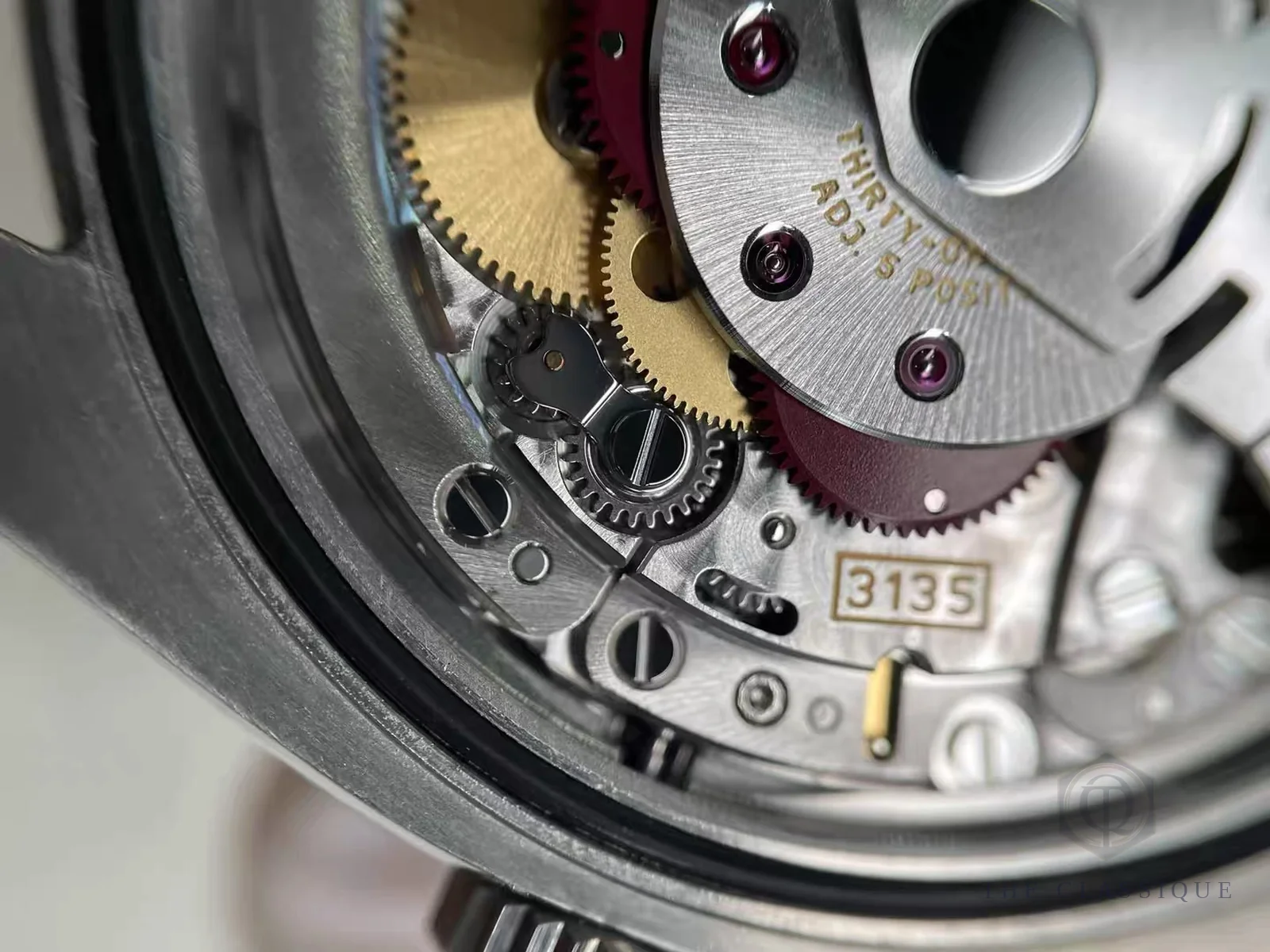 Bộ máy automatic caliber 3135 bên trong một chiếc Rolex đã qua sử dụng, khắc số hiệu máy trên rotor